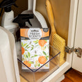 Load image into Gallery viewer, A Fresh Scents Orange & Honey - Sachet 3pk rests in a clear bin inside a cabinet with cleaning sprays and a wooden brush, next to a partially open white door for easy flameless fragrance.