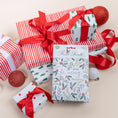 Load image into Gallery viewer, Be Merry Fresh Scents Scented Sachet 3pk on stack of Christmas presents.