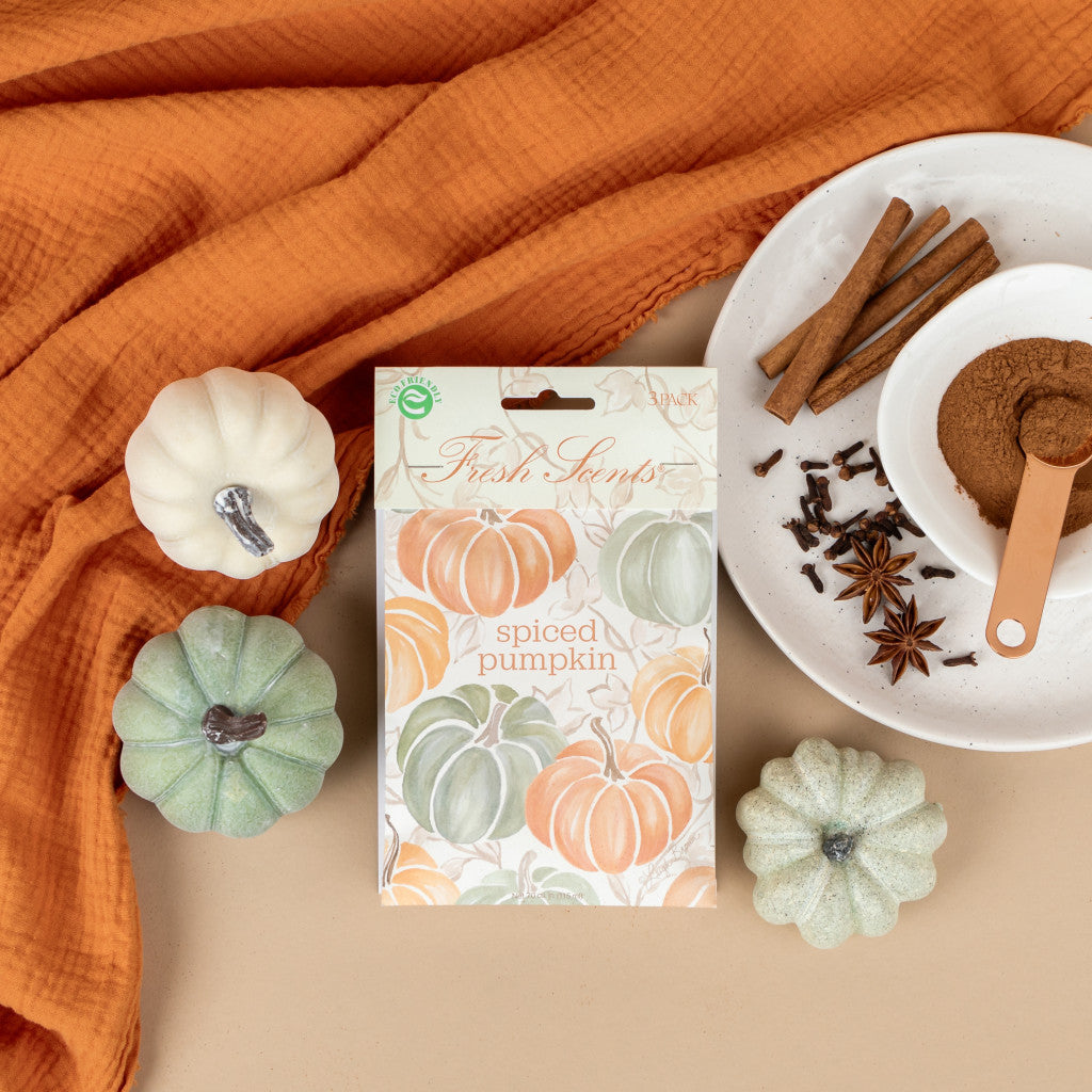 A pack of 'Spiced Pumpkin' scented sachets by Fresh Scents, depicted with a plate of spices and an orange blanket