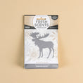 Load image into Gallery viewer, The Fresh Scents Woodland Sachet 3pk features a vanilla spice fragrance and comes in packaging with a moose silhouette and snowflakes on beige, offering long-lasting flameless freshness for any space.