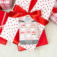 Load image into Gallery viewer, A white gift box with red polka dots and a red ribbon is topped with a Fresh Scents Merry Santas - Sachet 3pk, providing flameless, long-lasting fragrance among other festive presents.