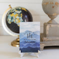 Load image into Gallery viewer, Adventure Mountain Sachet On Counter Top with Black Globe
