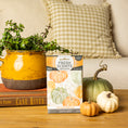 Load image into Gallery viewer, The Fresh Scents Spiced Pumpkin - Sachet 3pk fills your space with long-lasting fragrance, perfect for setting beside decor like potted plants, pumpkins, and books for a cozy touch.
