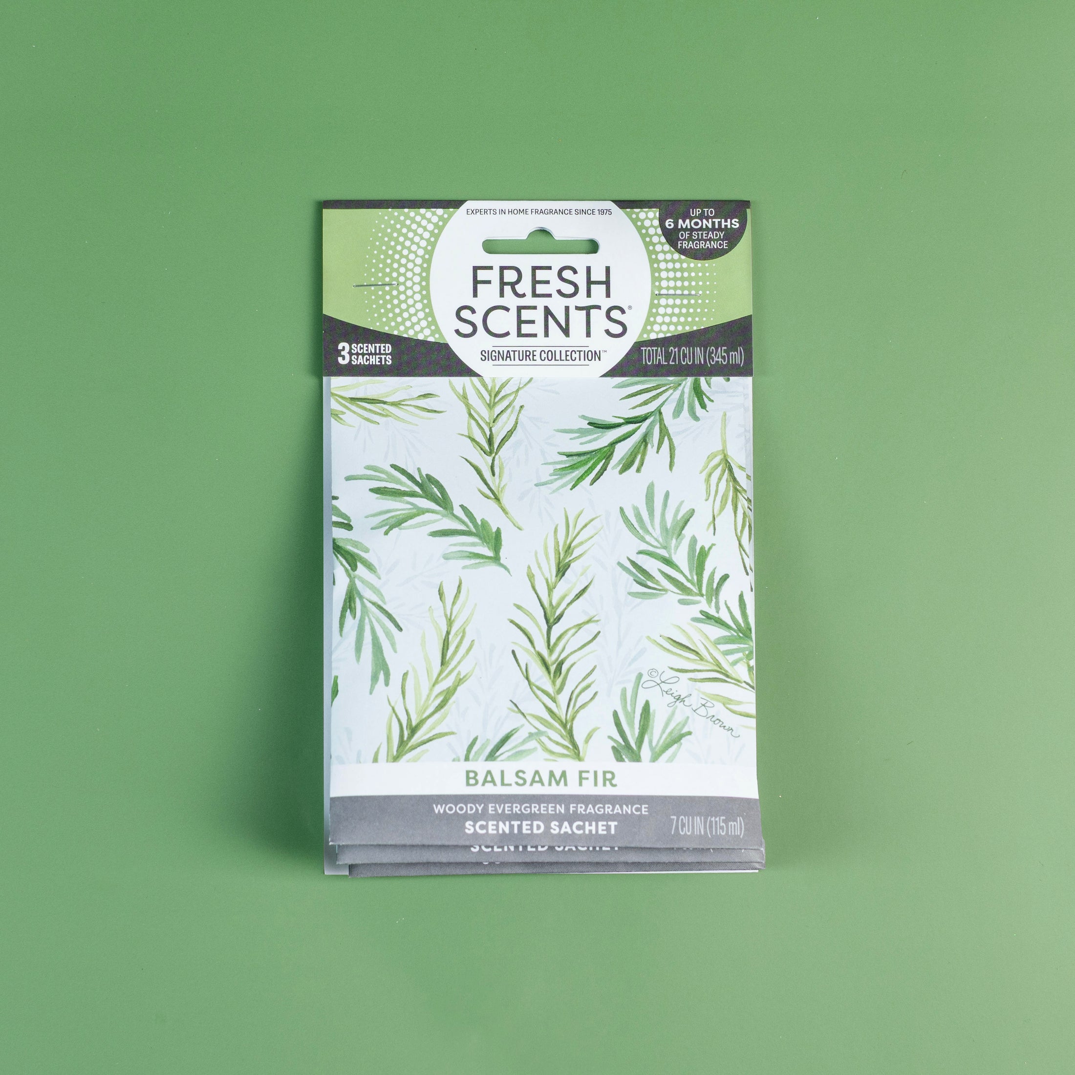 Fresh Scents Balsam Fir - Sachet 3pk features green fir branches on a white background over green. Enjoy long-lasting, flameless freshness with a woody evergreen scent.