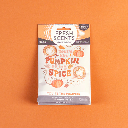 A 3-pack of "You’re the Pumpkin" scented sachets by Fresh Scents sits on an orange background, featuring pumpkin illustrations and offering a flameless, long-lasting pumpkin spice fragrance.
