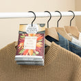Load image into Gallery viewer, The Fresh Scents Love with Fall - Sachet 3pk adds a spice fruit aroma to your closet, as a sachet printed with “Every year I fall in love with fall” hangs on a white rack among sweaters and denim for flameless fragrance.
