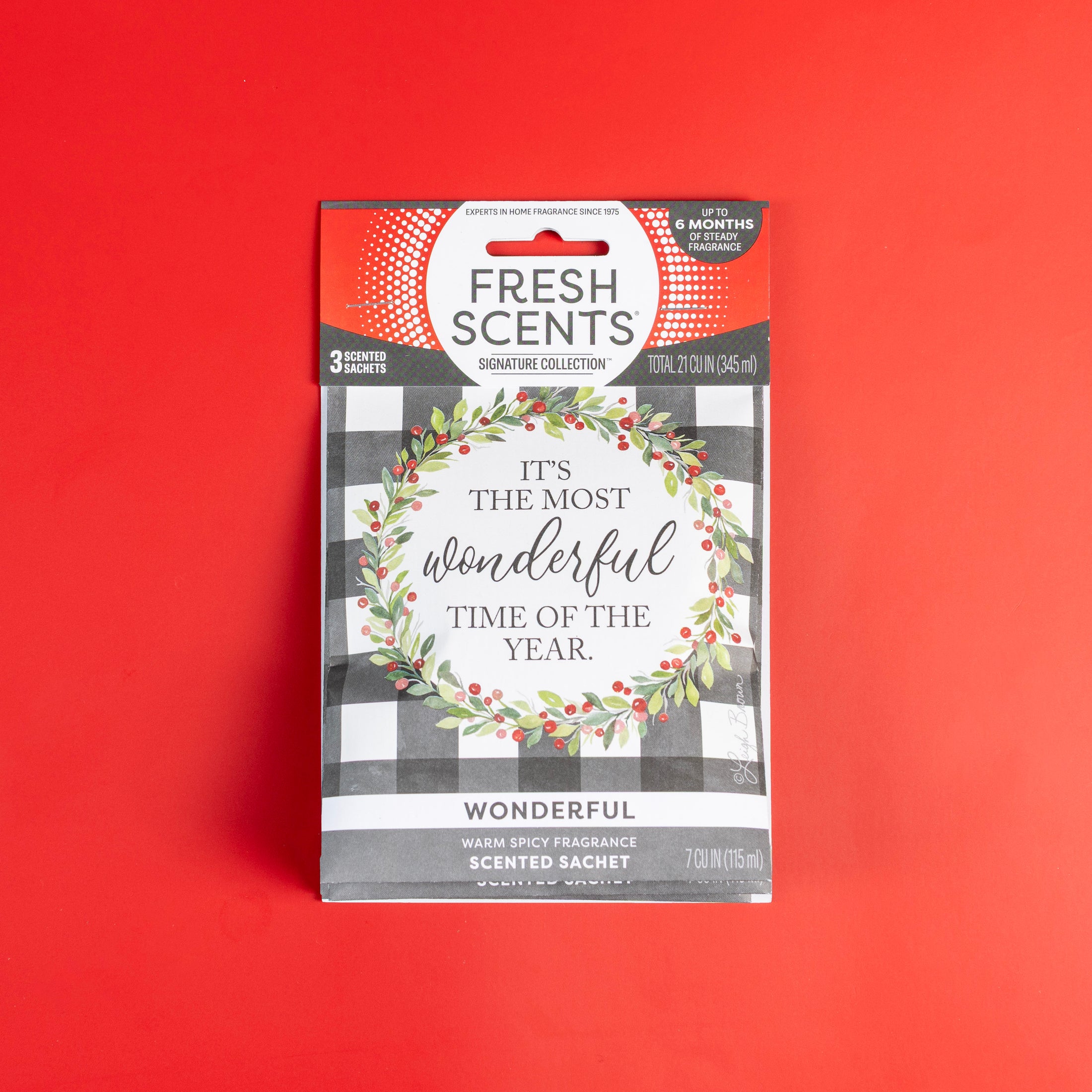 A Fresh Scents Wonderful - Sachet 3pk on a red background shows a wreath and "It's the most wonderful time of the year." This flameless air freshener features a warm, spicy, long-lasting scent.