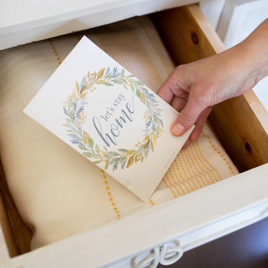 Hand Placing Let's Stay Home Scented Sachet in Drawer