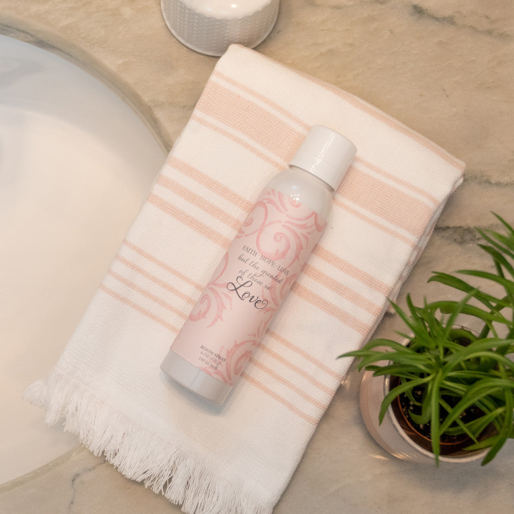 Faith Hope Love Fragrance in Room Spray Resting on Towel on Bathroom Counter