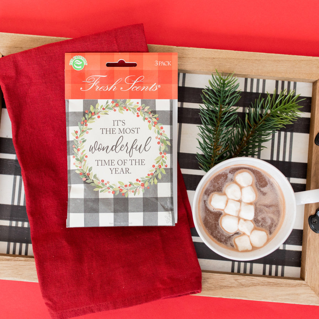 Wonderful Fresh Scents 3pk holiday scented sachet on decorative board with cup of hot chocolate